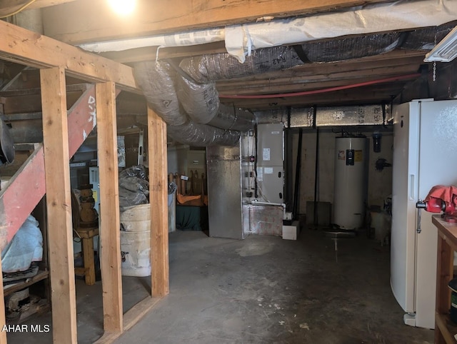 basement featuring white refrigerator and gas water heater