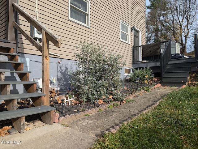 view of side of property featuring a wooden deck