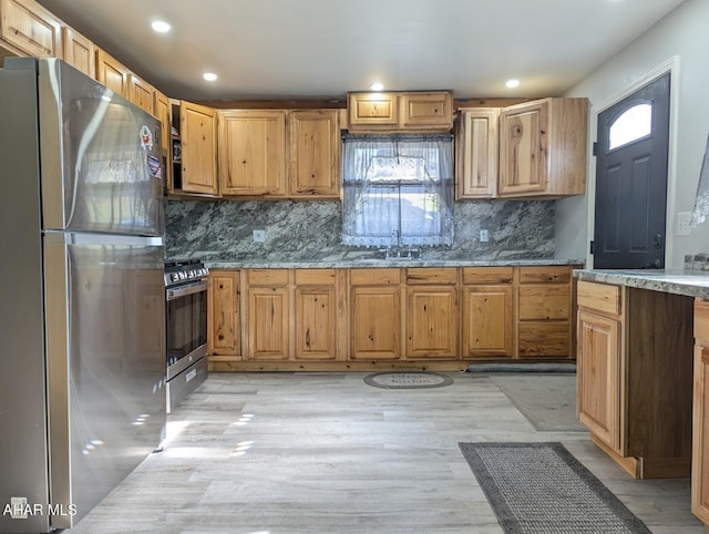 9802 Black Valley Rd, Everett, PA 15537 - kitchen with stainless steel appliances, decorative backsplash, stone countertops, recessed lighting, and light wood-style flooring