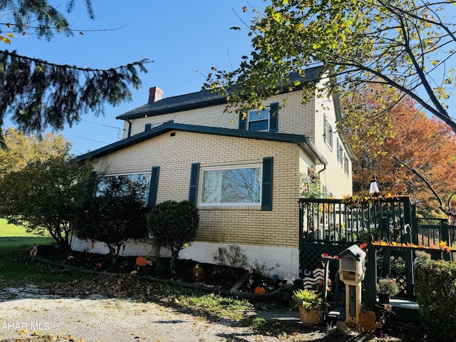 view of side of home with a wooden deck