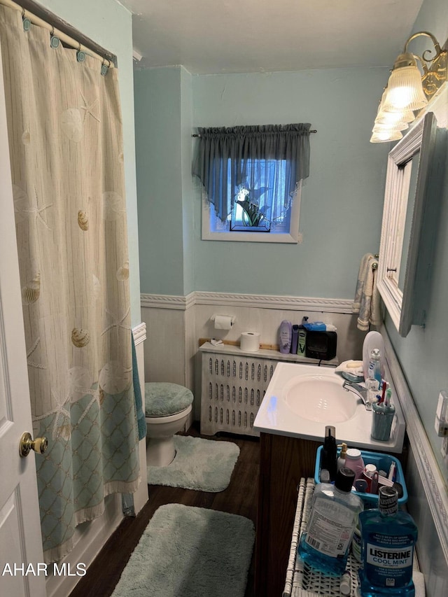 full bathroom featuring vanity, wood-type flooring, shower / tub combo, and toilet