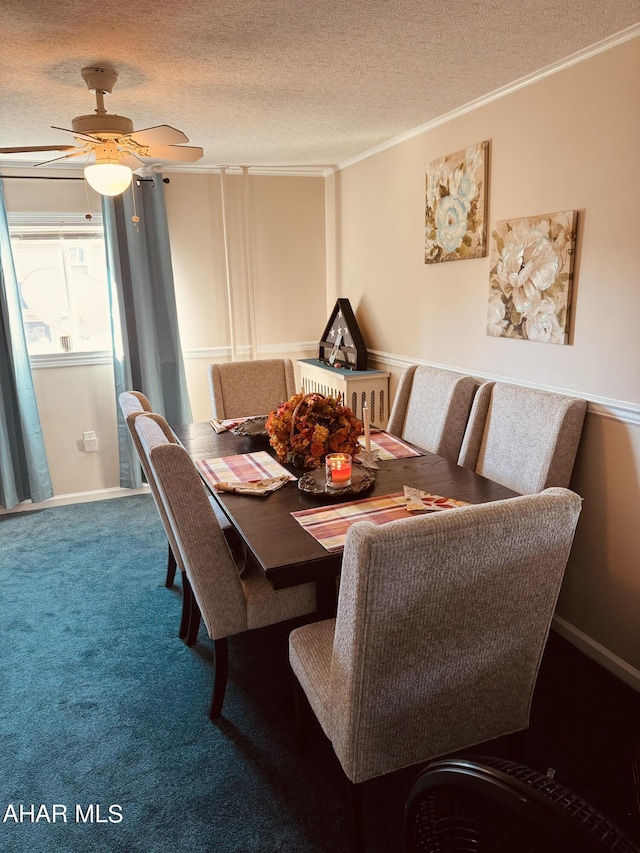 dining room featuring a textured ceiling, carpet floors, ceiling fan, and crown molding