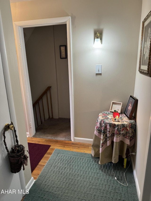 hallway with hardwood / wood-style flooring