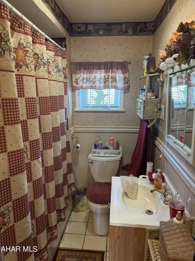 bathroom featuring tile patterned floors, vanity, toilet, and a shower with shower curtain