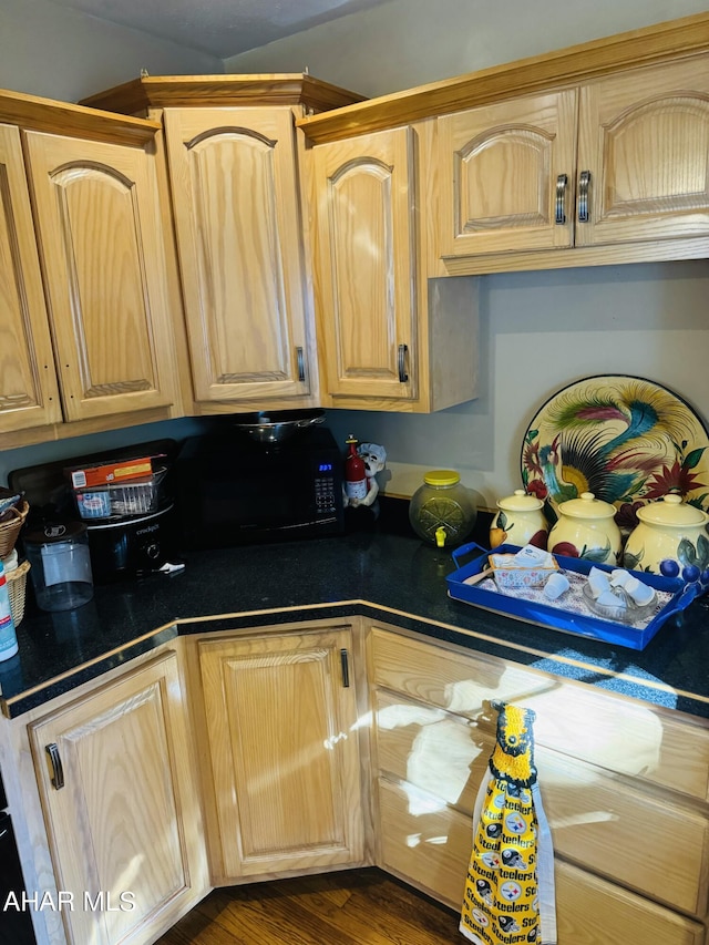 kitchen featuring light brown cabinetry and dark hardwood / wood-style floors