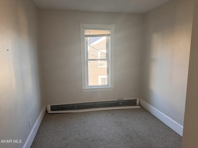 carpeted empty room featuring a baseboard radiator