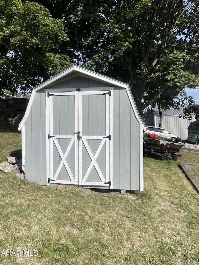 view of outdoor structure with a lawn