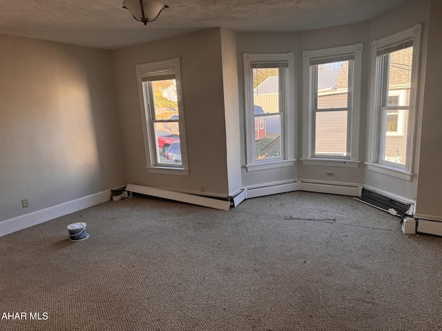 carpeted spare room featuring a textured ceiling and baseboard heating