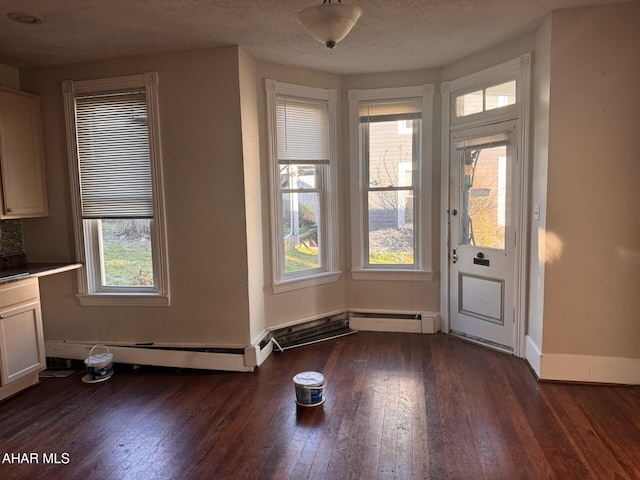 interior space featuring a textured ceiling and dark wood-type flooring