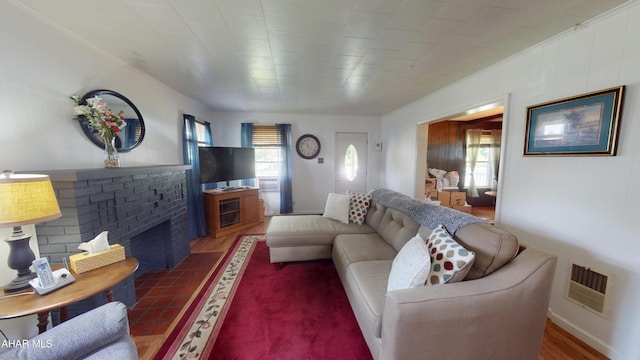 2513 Quail Ave, Altoona, PA 16602 - living room featuring plenty of natural light, a fireplace, and wooden walls