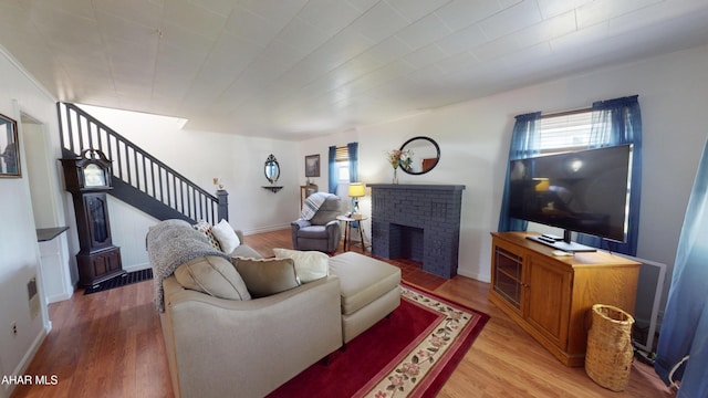 2513 Quail Ave, Altoona, PA 16602 - living area featuring stairs, light wood-style floors, and a fireplace