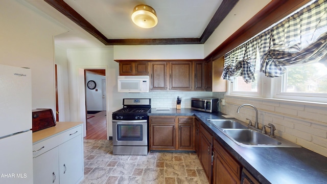 2513 Quail Ave, Altoona, PA 16602 - kitchen with stainless steel appliances, tasteful backsplash, light stone finish flooring, and dark countertops