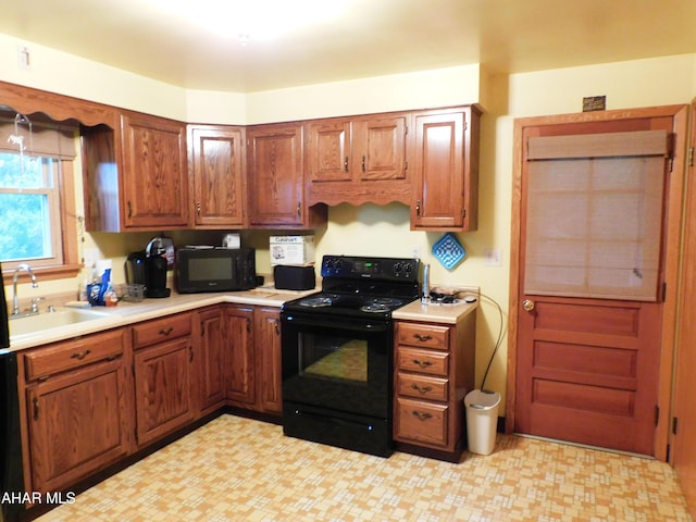 315-323 E 23rd Ave, Altoona, PA 16601 - kitchen featuring black appliances, light countertops, light flooring, and brown cabinets