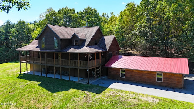 back of property featuring a patio, a sunroom, a deck, and a lawn