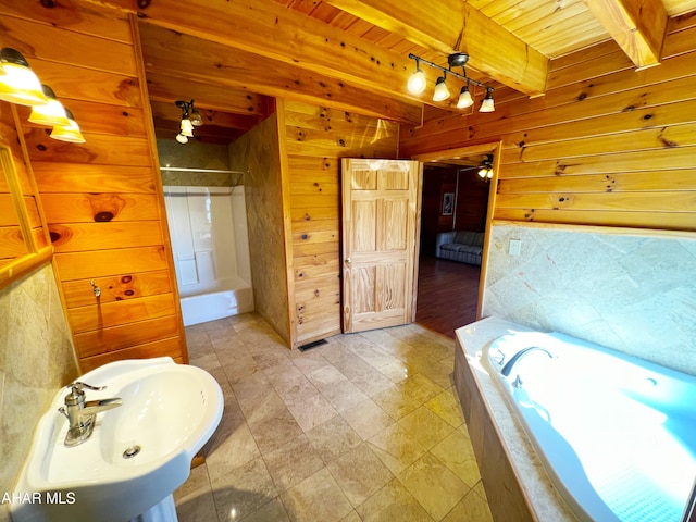 bathroom featuring sink, wood ceiling, ceiling fan, beam ceiling, and wooden walls