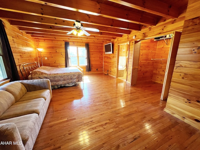 bedroom with hardwood / wood-style flooring, beam ceiling, and wood walls