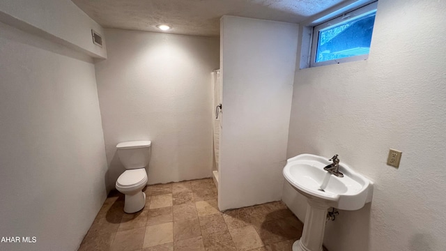 bathroom with curtained shower and toilet