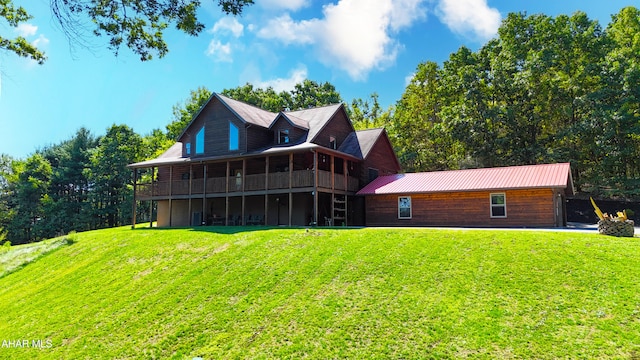 rear view of house featuring a yard