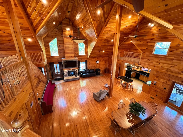 unfurnished living room with wood ceiling, a fireplace, hardwood / wood-style floors, and beam ceiling