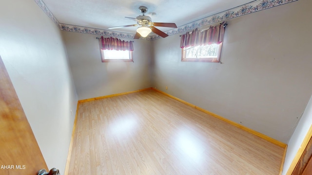 spare room featuring hardwood / wood-style floors and ceiling fan