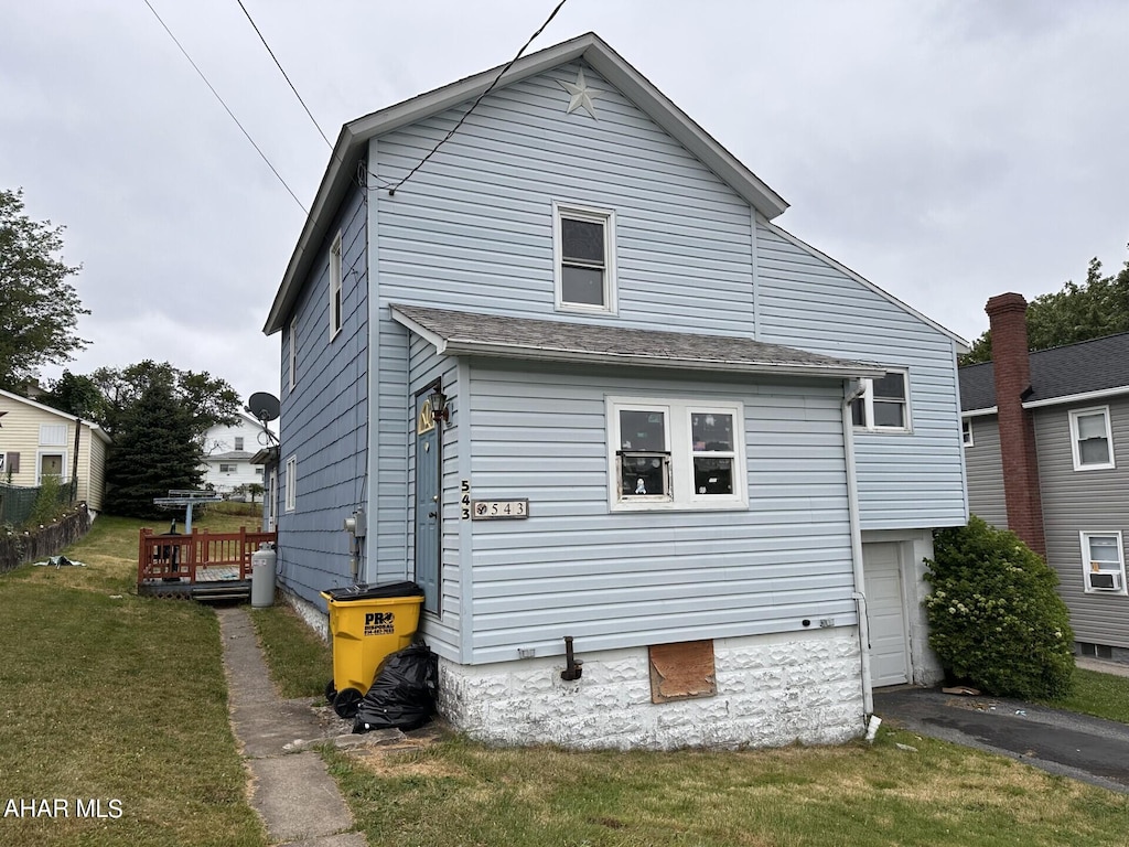 exterior space featuring a garage and a yard