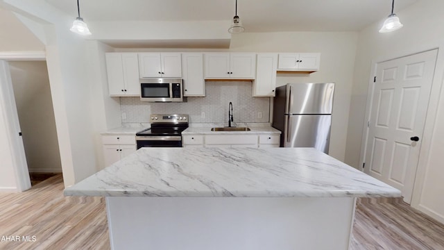 2602 W Chestnut Ave, Altoona, PA 16601 - kitchen featuring stainless steel appliances, white cabinetry, backsplash, and a center island