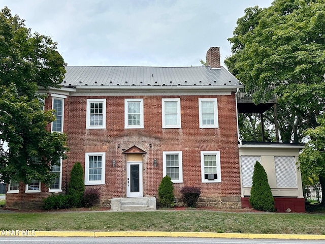 colonial-style house with a front yard