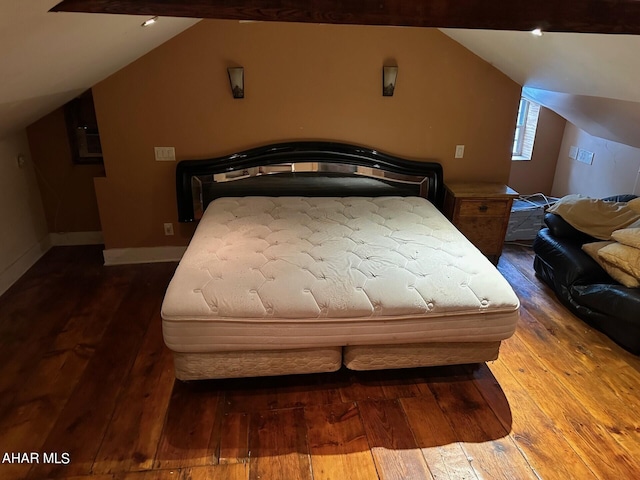 bedroom featuring hardwood / wood-style flooring and vaulted ceiling