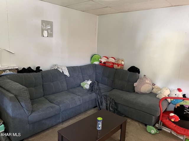 carpeted living room with a drop ceiling