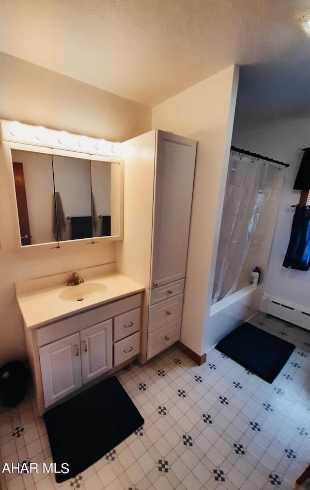 bathroom featuring shower / bath combination with curtain, vanity, and a baseboard radiator