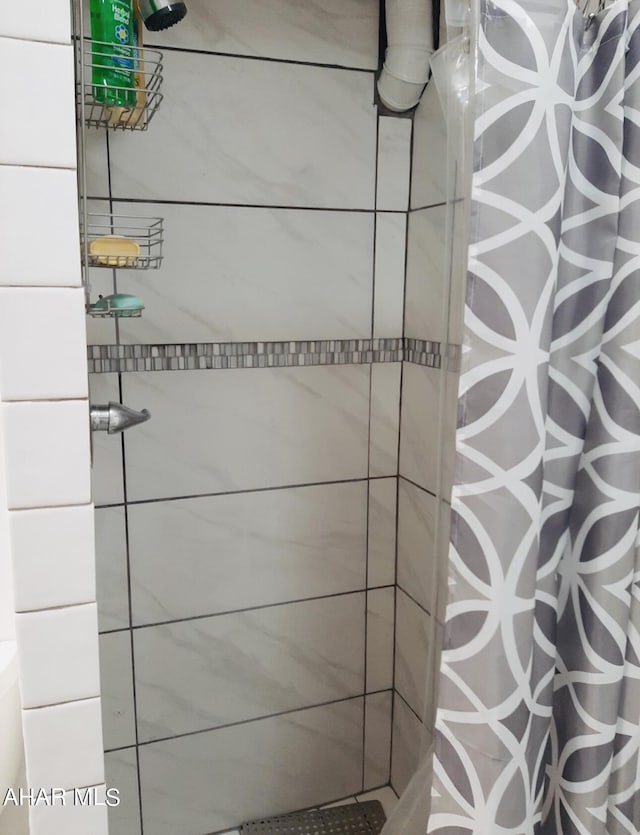 interior space featuring a shower with curtain