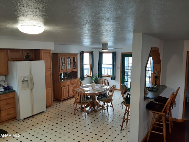 dining area featuring a textured ceiling