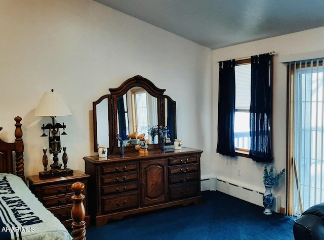 bedroom featuring dark carpet and baseboard heating