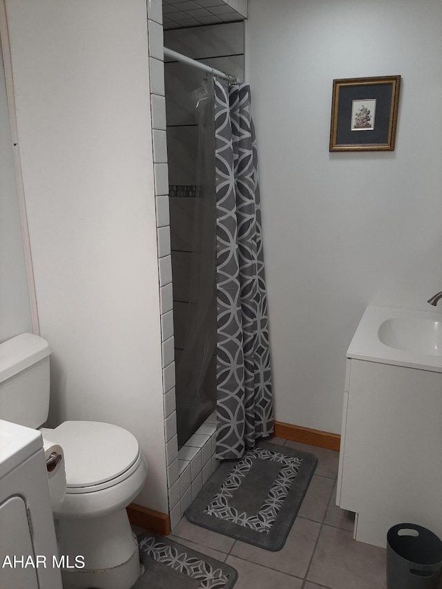 bathroom with tile patterned flooring, vanity, toilet, and a shower with shower curtain