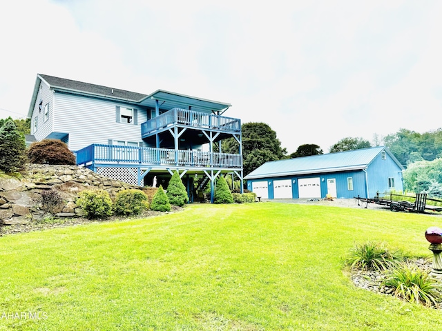 rear view of property with a yard, an outbuilding, a deck, and a garage