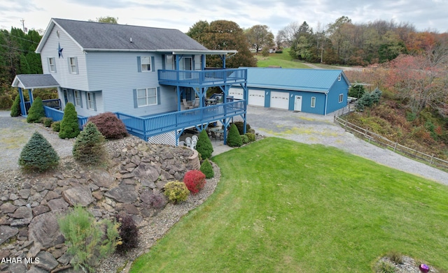 back of house featuring a lawn and a wooden deck