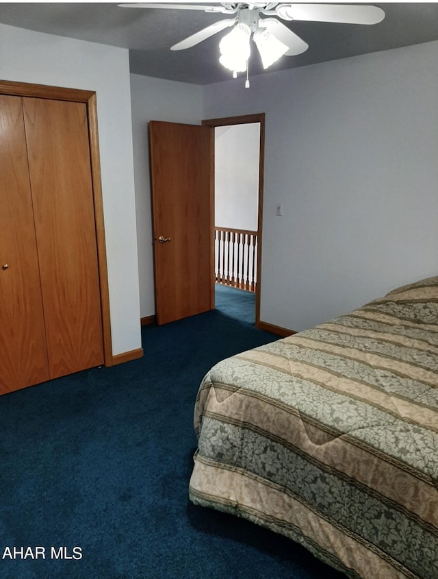 bedroom with a closet, dark carpet, and ceiling fan