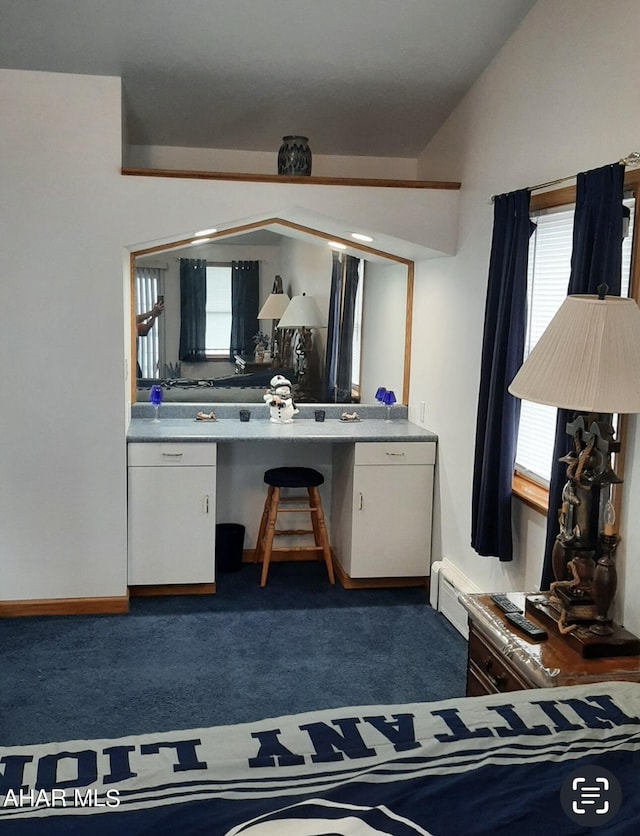 carpeted bedroom with lofted ceiling