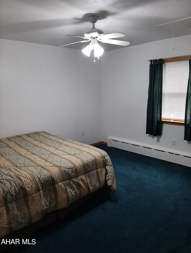 carpeted bedroom with ceiling fan and a baseboard radiator