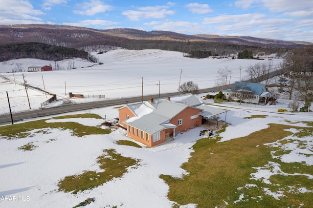 snowy aerial view featuring a mountain view