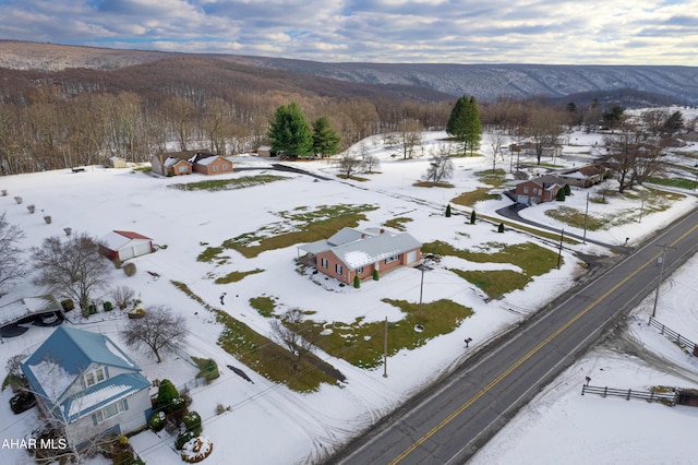 snowy aerial view with a mountain view