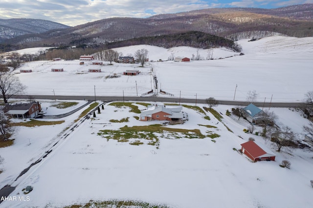 snowy aerial view featuring a mountain view