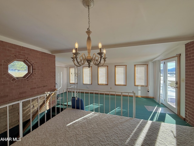 carpeted dining space featuring vaulted ceiling, brick wall, and a chandelier