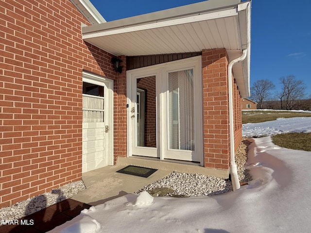 view of snow covered property entrance