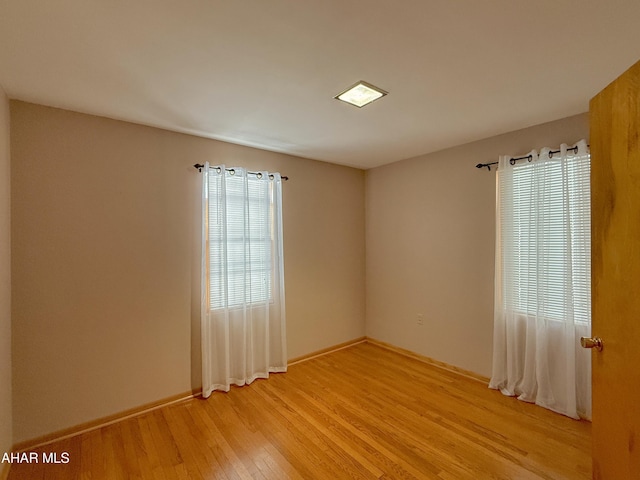 unfurnished room featuring light hardwood / wood-style floors