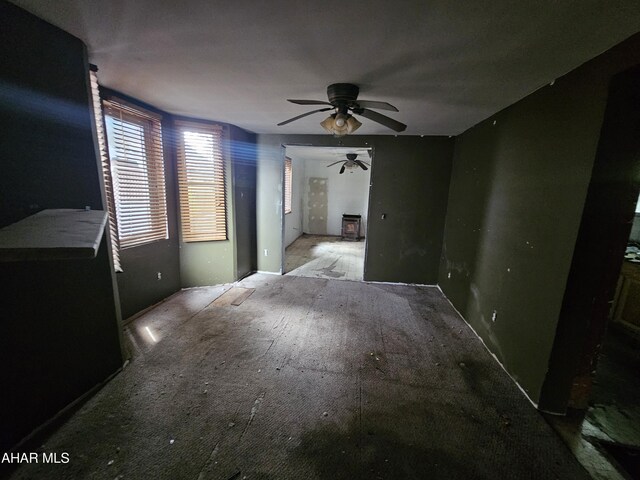 625 N 5th Ave, Altoona, PA 16601 - unfurnished living room with a ceiling fan and a wood stove