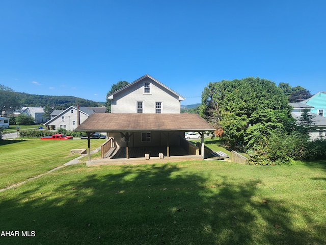 rear view of property featuring a yard