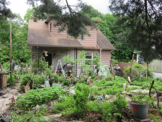 210 Hazel St, Johnstown, PA 15909 - back of property with a chimney and a shingled roof