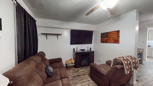 1407 N 5th Ave, Altoona, PA 16601 - living room with wood finished floors, a ceiling fan, and a textured ceiling