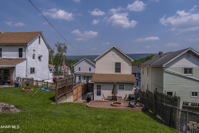 1407 N 5th Ave, Altoona, PA 16601 - back of property with a fire pit and a fenced backyard